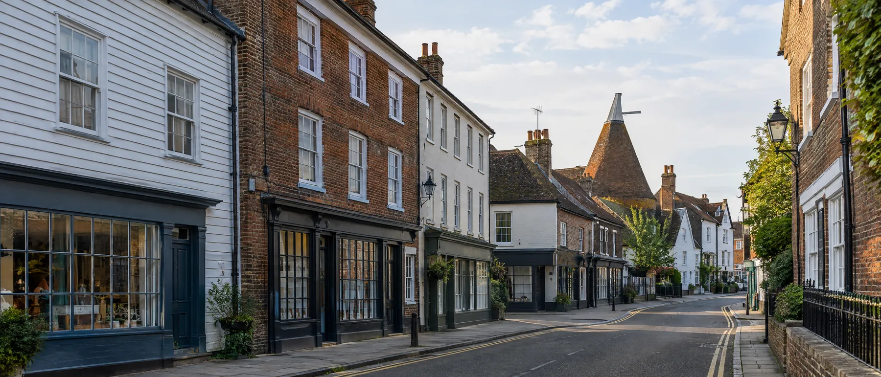 Weatherboarded and Georgian buildings with flats above shops in a Kent town