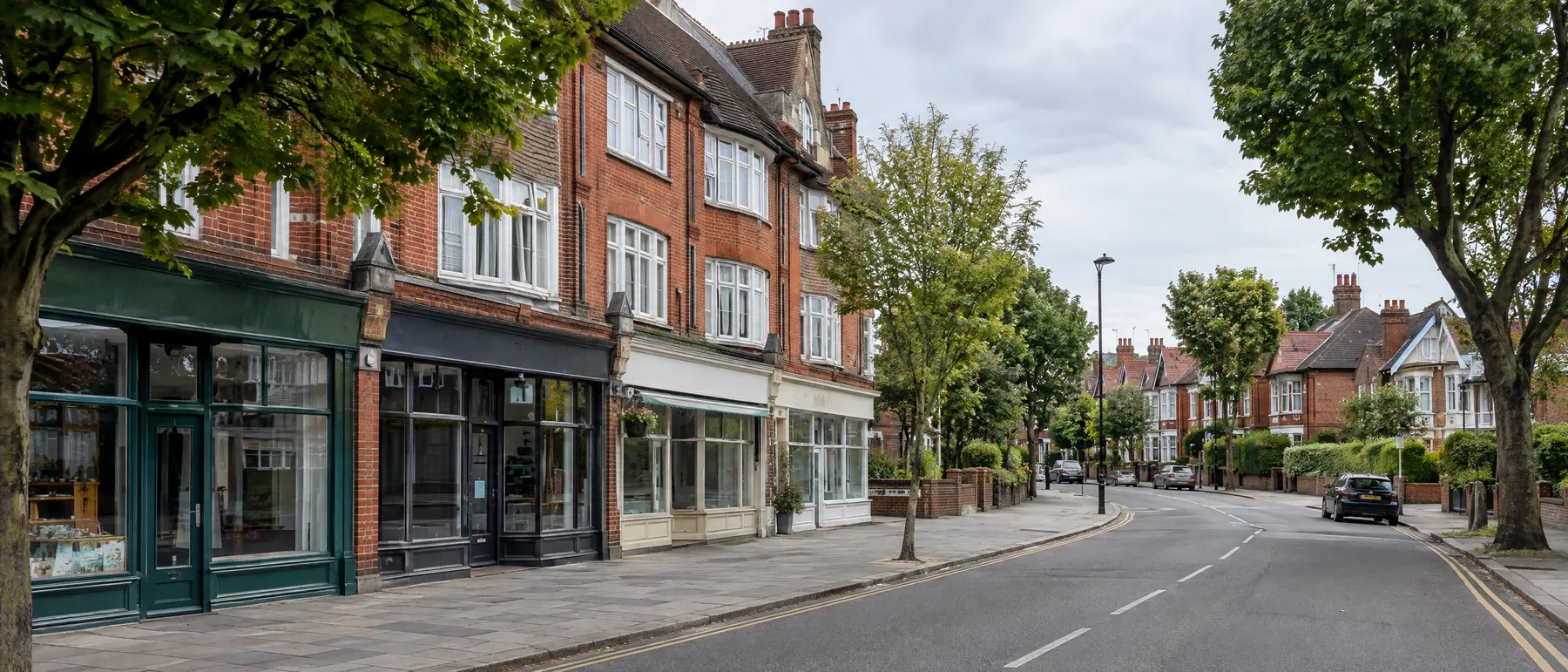Shops with flats above and Edwardian houses on a North London street