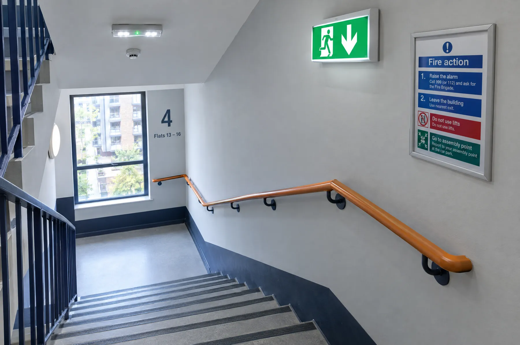 Protected stairwell with fire exit sign and emergency lighting